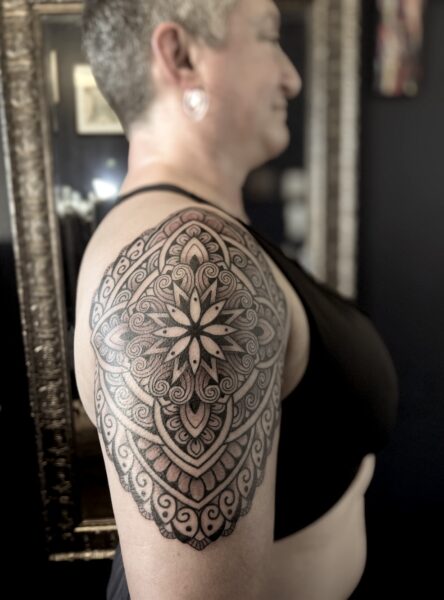 Bold interesting upper arm mandala tattoo